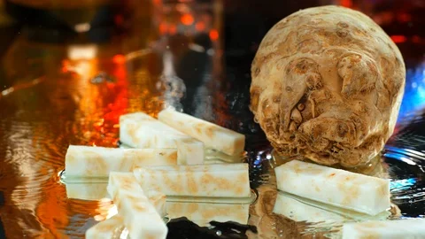 Sliced celery root falling on a table with water in slow motion 4k, phantom Stock Footage 114970030