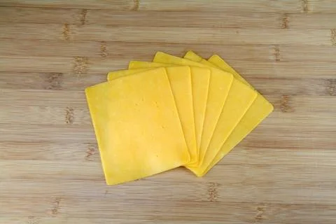 Sliced cheddar cheese Stock Photos