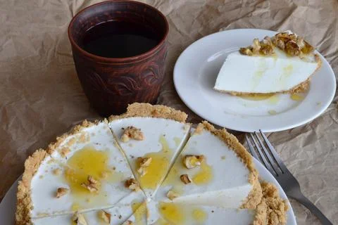 Sliced cheesecake and tea on the table Stock Photos