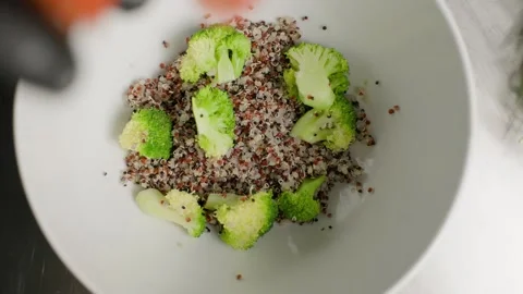Sliced Cherry Tomatoes Dropping into a Quinoa Bowl Stock Footage 313059464