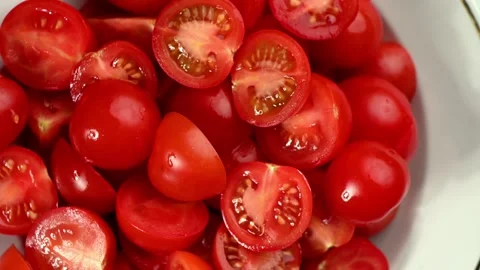 Sliced Cherry Tomatoes Spinning on Dark Surface. Top-Down Seamless Loop, Juicy Stock Footage 326242339