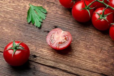 Sliced cherry tops on a wooden background. Stock Photos