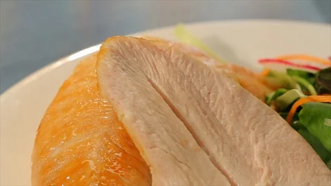 Sliced chicken or turkey with dripping orange glaze. CU Stock Footage 102136133