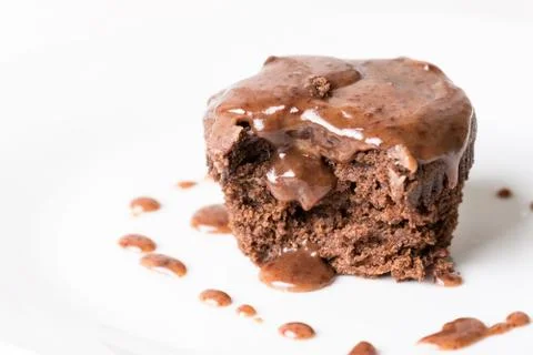 Sliced chocolate cup cake muffing with topping melting chocolate cream above  Stock Photos