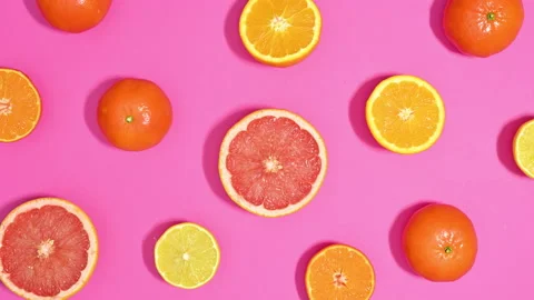 Sliced Citrus fruits pattern move on pink theme. Stop motion flat lay Video stock 169303653