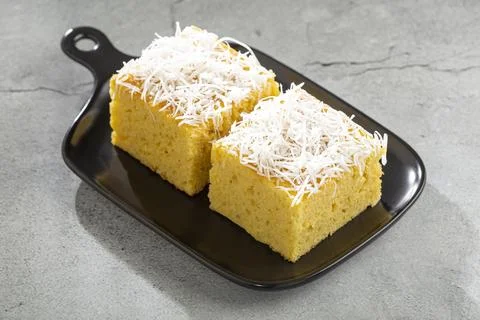 Sliced ??coconut cake on the table. Stock Photos