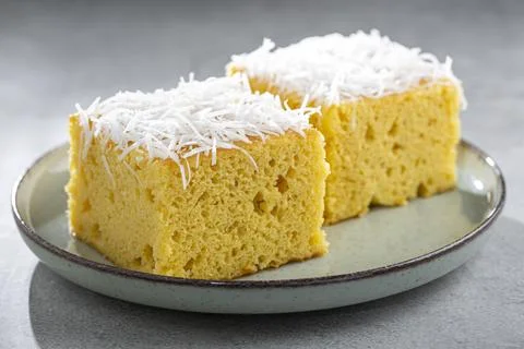 Sliced ??coconut cake on the table. Stock Photos