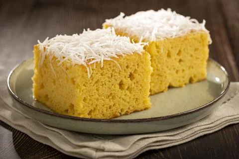 Sliced ??coconut cake on the table. Stock Photos