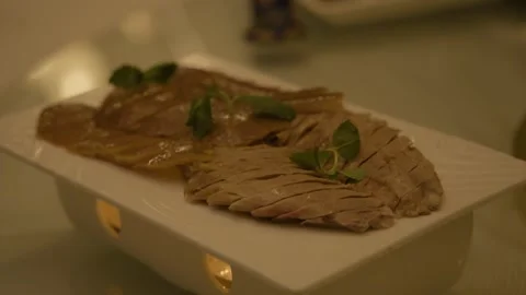 Sliced Cooked Meat with Garnish on Platter in Beijing Restaurant Dining Scene Stock Footage 345783436