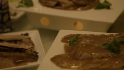 Sliced Cooked Meat Served on Platter with Garnish in Beijing Restaurant Interior Stock Footage 345783555