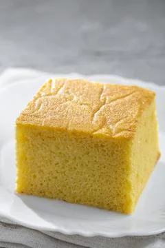 Sliced ??cornmeal cake on the table. Stock Photos