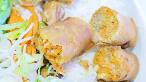 Sliced crispy fried Vietnamese egg roll over rice vermicelli noodle Stock Footage 335851571