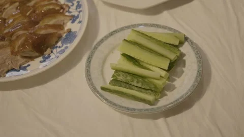Sliced Cucumber and Cooked Meat Served on Plates at Restaurant Table in Beijing Stock Footage 345769747