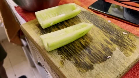 Sliced Cucumber on Cutting Board for Fresh Ceviche Preparation in Kitchen Stock Footage 334052771