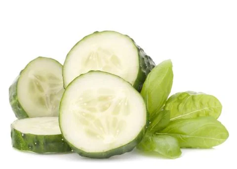 Sliced cucumber vegetable and basil leaves still life Stock Photos