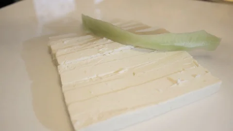 Sliced cucumbers, fall to cottage cheese. Cucumbers sliced in long pieces. Stock Footage 125343254