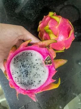 Sliced dragon fruit on dark surface Stock Photos