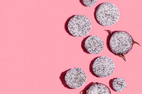 Sliced dragon fruit pattern on pink background with free copy space. Different Stock Photos