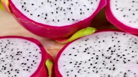 Sliced Dragon Fruit on Wooden Surface Stockbeeldmateriaal 310283244