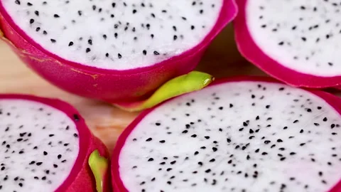 Sliced Dragon Fruit on Wooden Surface Stockbeeldmateriaal 310284091