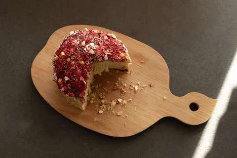 Sliced ??Easter cake on a board with crumbs Stock Photos