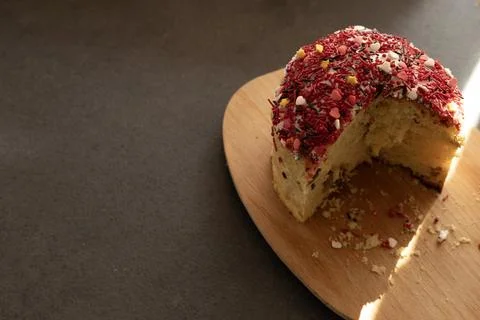 Sliced ??Easter cake on a board with crumbs, copy space Stock Photos