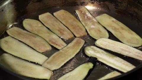Sliced eggplant frying in the pan Stock Footage 73477633
