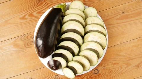 Sliced eggplant on a plate. Video stock 296879252