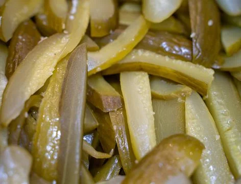 Sliced Fermented cucumbers background. pickles Photos
