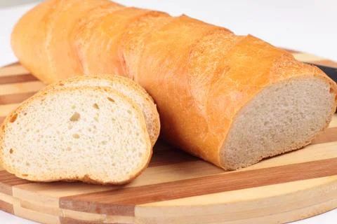 Sliced fresh bread on board Stock Photos