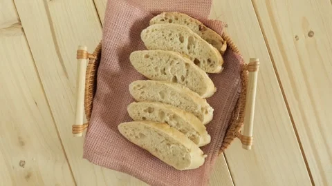 Sliced fresh bread spinning in a basket Stock Footage 336037961