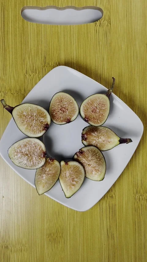 Sliced Fresh Figs Arranged on White Plate Over Natural Wooden Surface Food Stock Footage 345274449