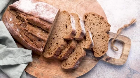 Sliced fresh homemade rye bread on cutting board Stock Footage 336179658