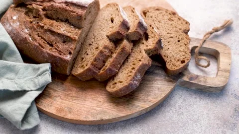 Sliced fresh homemade rye bread on cutting board Stock Footage 336307989