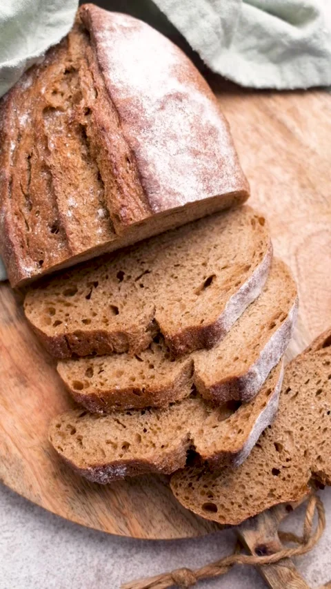 Sliced fresh homemade rye bread on cutting board Stock Footage 336550142