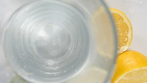 Sliced fresh lime citrus fruit from above in a drinking glass with whole lime Stock Footage 88510906