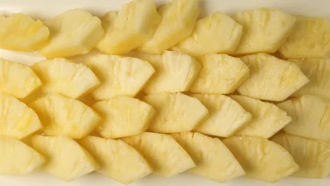 Sliced fresh pineapple pieces isolated on white background Stock Footage 344604534