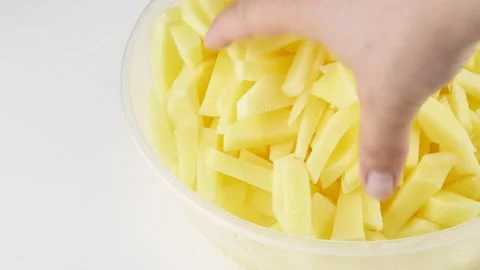 Sliced fresh potatoes.Vegetable in a clear plastic bowl. Stock-Footage 136110913