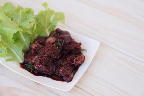 Sliced fresh raw beef to small pieces, mixed with Thai herbs ingredients and blo Foto stock