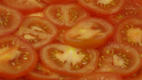 Sliced fresh ripe red tomatoes rotate on a plate Stock Footage 110286678