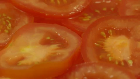 Sliced fresh ripe red tomatoes rotate on a plate Stock Footage 110287317