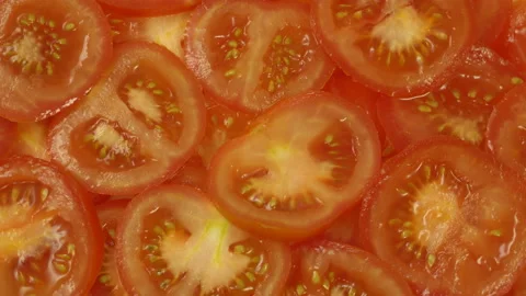 Sliced fresh ripe red tomatoes rotate on a plate Stock Footage 110287661