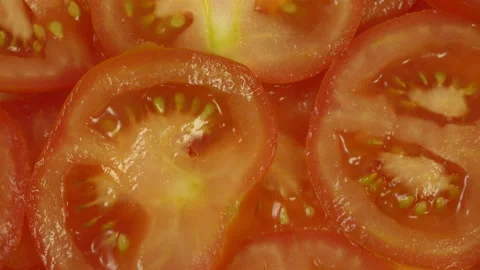 Sliced fresh ripe red tomatoes rotate on a plate Stock Footage 110288128