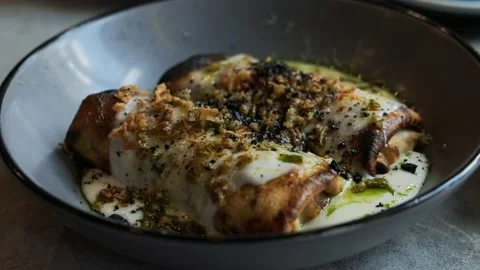 Sliced fried thin pancakes with meat and cream sauce. Delicious french crepe Stock Footage 220515795