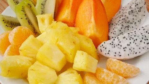 Sliced fruit on a plate. 스톡 동영상 241482751