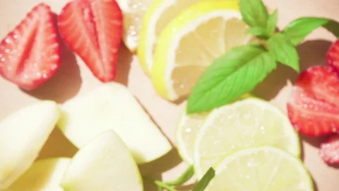 Sliced fruit in a soft focus and a decanter with a chilled drink Stock Footage 90420245