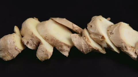 Sliced ginger root on black background Stock Footage 96694207