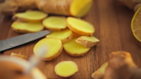 Sliced ginger root lies chopped on a cutting board its vibrant yellow flesh Stock Footage 331361512
