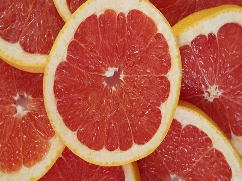Sliced grapefruit background Video stock 80363644