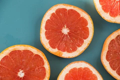 Sliced grapefruit on the blue background Stock Photos